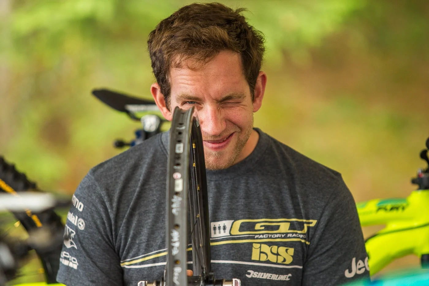 Pete smiling while checking a wheel in the GT Factory Racing pits