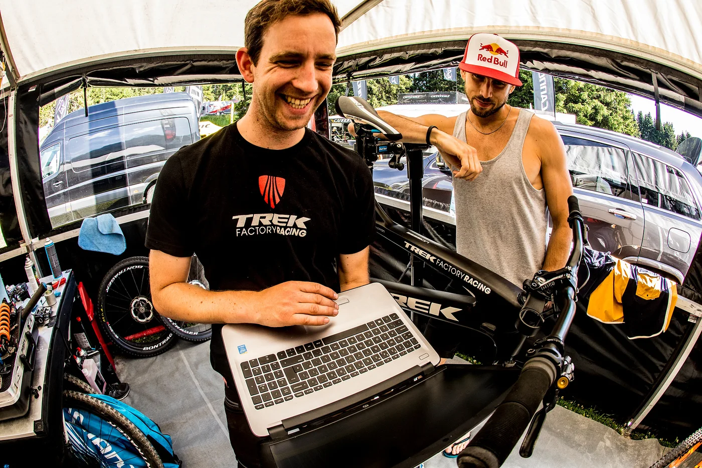 Pete at a laptop in the Trek pits, with Gee Atherton alongside